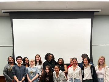 A diverse group of students smiles in a group photo.